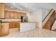 Bright kitchen with stainless steel appliances, a kitchen island, and staircase access at 6032 S Pioneer Way, Las Vegas, NV 89113