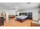 Bright, spacious main bedroom with a ceiling fan and hardwood flooring at 6032 S Pioneer Way, Las Vegas, NV 89113