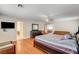 Large main bedroom features ceiling fan, hardwood floors, and a doorway at 6032 S Pioneer Way, Las Vegas, NV 89113