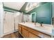 Bathroom featuring double sinks, wood cabinets, and a glass-enclosed shower at 6056 Flowering Plum Ave, Las Vegas, NV 89142