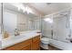 Standard bathroom with a shower-tub combo with glass doors, sink with vanity, and a toilet at 6056 Flowering Plum Ave, Las Vegas, NV 89142
