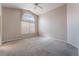Bedroom with neutral carpeting and a large window at 6056 Flowering Plum Ave, Las Vegas, NV 89142