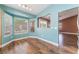 Cozy dining area with large windows, hardwood floors and an open access to the living room and kitchen at 6056 Flowering Plum Ave, Las Vegas, NV 89142