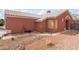 Exterior of the home with desert landscaping and a charming rock river flowing along the side of the home at 6056 Flowering Plum Ave, Las Vegas, NV 89142
