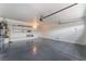 Spacious two car garage featuring ample room for storage and epoxy flooring at 6056 Flowering Plum Ave, Las Vegas, NV 89142