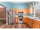 Bright kitchen with stainless steel appliances, light wood cabinets and eat in dining area at 6056 Flowering Plum Ave, Las Vegas, NV 89142