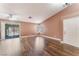 Bright living room with wood floors, vaulted ceilings, and sliding glass doors to the patio at 6056 Flowering Plum Ave, Las Vegas, NV 89142