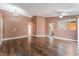 Spacious living room with an open floor plan, hardwood floors, and an open access to the kitchen at 6056 Flowering Plum Ave, Las Vegas, NV 89142