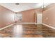 Open living room features vaulted ceiling, wood floors, and abundant natural light at 6056 Flowering Plum Ave, Las Vegas, NV 89142