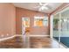Living room with hardwood floors, views into the kitchen and the sliding glass door to the sunroom at 6056 Flowering Plum Ave, Las Vegas, NV 89142