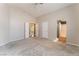 Spacious main bedroom with plush carpeting and access to an ensuite bathroom at 6056 Flowering Plum Ave, Las Vegas, NV 89142