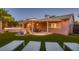 Expansive backyard featuring artificial turf, a covered patio, a built in tub, and stylish outdoor furniture at 6316 Bluejay Way, Las Vegas, NV 89146