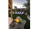 Charming backyard featuring four white lounge chairs and decorative accent lights surrounded by desert landscaping at 6316 Bluejay Way, Las Vegas, NV 89146