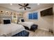 Bright bedroom with two twin beds, accent wall art and dark blue ottomans at the foot of each bed at 6316 Bluejay Way, Las Vegas, NV 89146