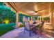 Inviting covered patio with a dining table set, ceiling fan, tasteful decor, and lush green backyard at 6316 Bluejay Way, Las Vegas, NV 89146