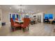 Bright dining room showcasing open floor plan into the eat-in kitchen with new stainless appliances and breakfast bar seating at 6316 Bluejay Way, Las Vegas, NV 89146