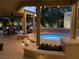 Picturesque hot tub area with ambient lighting, elegant landscaping, and seamless access to covered seating areas at 6316 Bluejay Way, Las Vegas, NV 89146