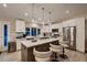 Kitchen features a large center island with seating, modern appliances, and white cabinetry at 6316 Bluejay Way, Las Vegas, NV 89146