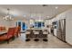 Bright open kitchen with stainless steel appliances, center island with seating and wood flooring at 6316 Bluejay Way, Las Vegas, NV 89146