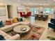 Open-concept living room and dining area with breakfast bar, comfortable seating, and modern decor at 6316 Bluejay Way, Las Vegas, NV 89146