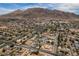 Aerial neighborhood view with streets, houses, and mountains in the background at 6520 Turtle Hill Rd, Las Vegas, NV 89110