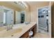 Bathroom features double vanity, wood cabinets, and doorway to adjacent bedroom at 6520 Turtle Hill Rd, Las Vegas, NV 89110