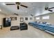 Large bedroom featuring three beds, tile floors, ceiling fans, and a comfortable seating area at 6520 Turtle Hill Rd, Las Vegas, NV 89110