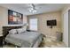 Comfortable bedroom with modern bed frame, TV, closet, and large vibrant artwork at 6520 Turtle Hill Rd, Las Vegas, NV 89110