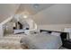Bright bedroom showcases three beds, neutral paint, and unique sloped ceilings at 6520 Turtle Hill Rd, Las Vegas, NV 89110