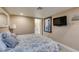 Comfortable bedroom with neutral tones, TV, and stylish bedding at 6520 Turtle Hill Rd, Las Vegas, NV 89110