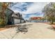Wide driveway leading to a three-car garage, set against a backdrop of a landscaped yard and blue sky at 6520 Turtle Hill Rd, Las Vegas, NV 89110