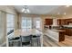 Bright kitchen featuring wood cabinets, granite countertops, stainless steel appliances, and a large table at 6520 Turtle Hill Rd, Las Vegas, NV 89110