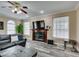 Cozy living room with a fireplace and modern gray flooring at 6520 Turtle Hill Rd, Las Vegas, NV 89110