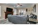 Comfortable living room featuring a fireplace, leather couches, and gray flooring at 6520 Turtle Hill Rd, Las Vegas, NV 89110