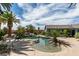 Beautiful backyard with a freeform pool, mature palm trees, rock features, and a covered patio at 6520 Turtle Hill Rd, Las Vegas, NV 89110