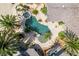 An aerial view of a backyard oasis with a uniquely shaped pool, spa, and palm trees at 6520 Turtle Hill Rd, Las Vegas, NV 89110