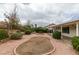 This backyard has gravel landscaping, a covered patio, and a seating area at 709 Heritage Point Dr, Henderson, NV 89002