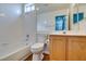 This bathroom has a tub and shower combination with white tile and a wood vanity at 709 Heritage Point Dr, Henderson, NV 89002