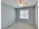 This bedroom has gray carpeting, a ceiling fan, and a large window with blinds at 709 Heritage Point Dr, Henderson, NV 89002