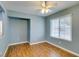 This bedroom has vinyl wood flooring, a ceiling fan, and a large window with blinds at 709 Heritage Point Dr, Henderson, NV 89002