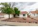 Attractive single-level home with red rock landscaping, mature trees, and a tile roof at 709 Heritage Point Dr, Henderson, NV 89002
