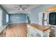 Open floor plan kitchen featuring an island, stainless steel refrigerator, and wood floors at 709 Heritage Point Dr, Henderson, NV 89002
