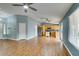 Spacious living area with modern ceiling fans, wood-look floors, and a view of the kitchen at 709 Heritage Point Dr, Henderson, NV 89002