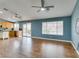Bright living area with wood-look floors, natural light, and an open concept to the kitchen at 709 Heritage Point Dr, Henderson, NV 89002