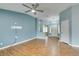 Spacious living room featuring wood floors, ceiling fan, and ample natural light at 709 Heritage Point Dr, Henderson, NV 89002