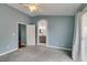 This main bedroom features gray carpeting, a ceiling fan, and an archway to the bathroom at 709 Heritage Point Dr, Henderson, NV 89002