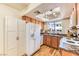 Well-lit kitchen boasting white appliances, granite countertops, and ample storage space at 7200 Pirates Cove Rd # 2071, Las Vegas, NV 89145
