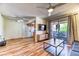 Bright living room featuring wood floors, a ceiling fan, and access to the kitchen at 7200 Pirates Cove Rd # 2071, Las Vegas, NV 89145