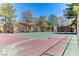 Community tennis court surrounded by trees and landscaping at 7200 Pirates Cove Rd # 2071, Las Vegas, NV 89145