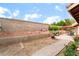 Spacious backyard featuring desert landscaping, patio, BBQ, and block fencing at 7517 Elk Meadows Ct, Las Vegas, NV 89131